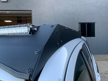 Load image into Gallery viewer, Close up of front right corner of Economy Roof Rack on a white Toyota Tacoma - Cali Raised LED